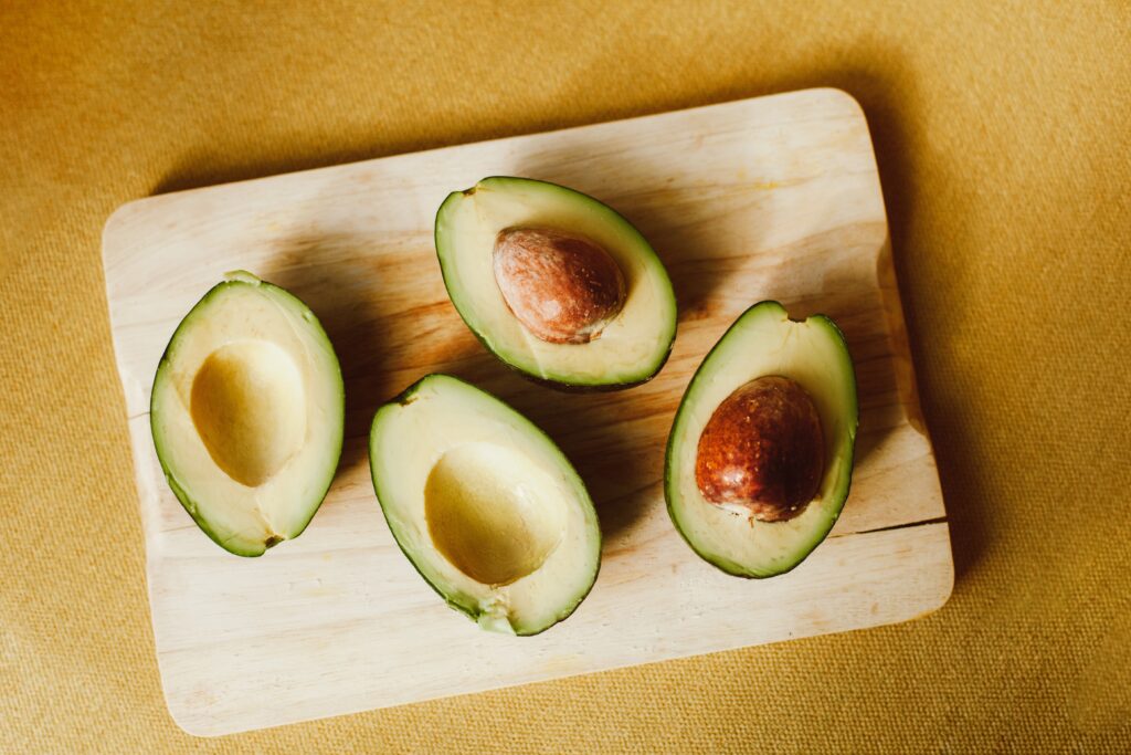 Two avocados cut in half