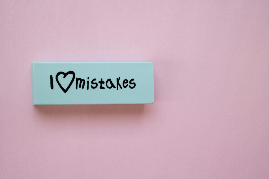 A piece of plastic that says I heart mistakes
