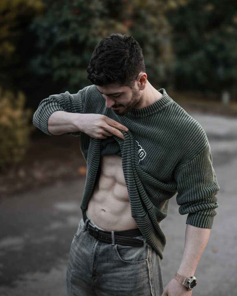 A guy lifting up his sweater showing his very fit abs. Keto and Gut Health