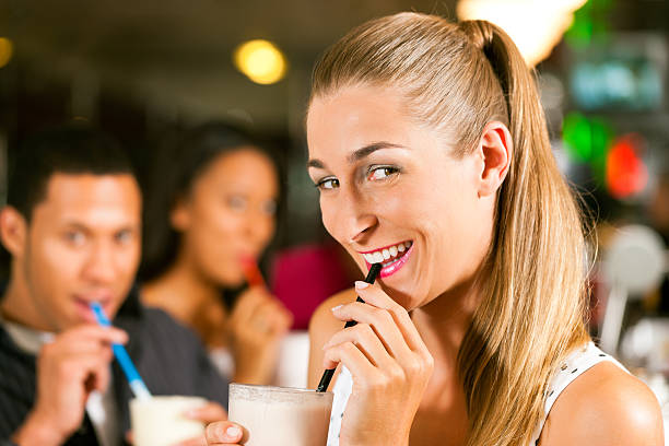 Keto Chow Full Review - Friends drinking milkshakes in a bar and have lots of fun; focus on the woman in front